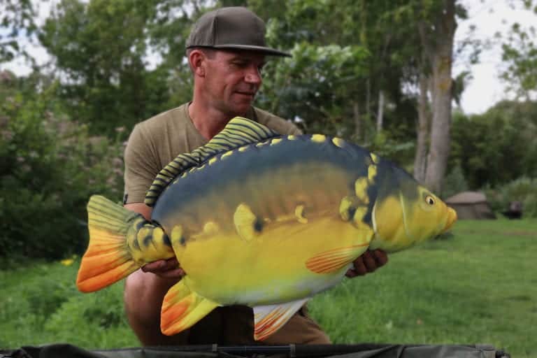 Man holding large fish outdoors