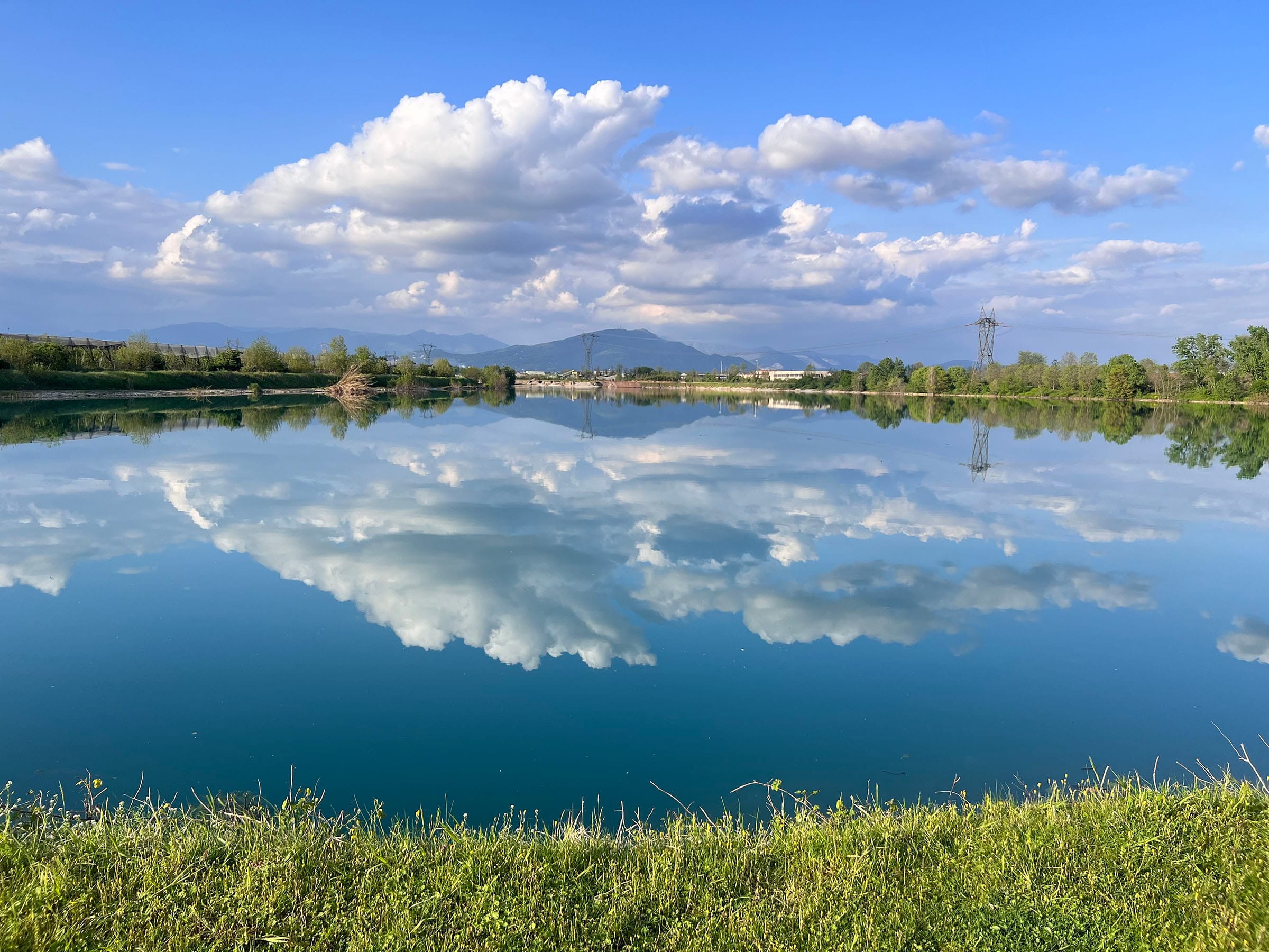 Clouds reflected in a calm lake on a sunny day.