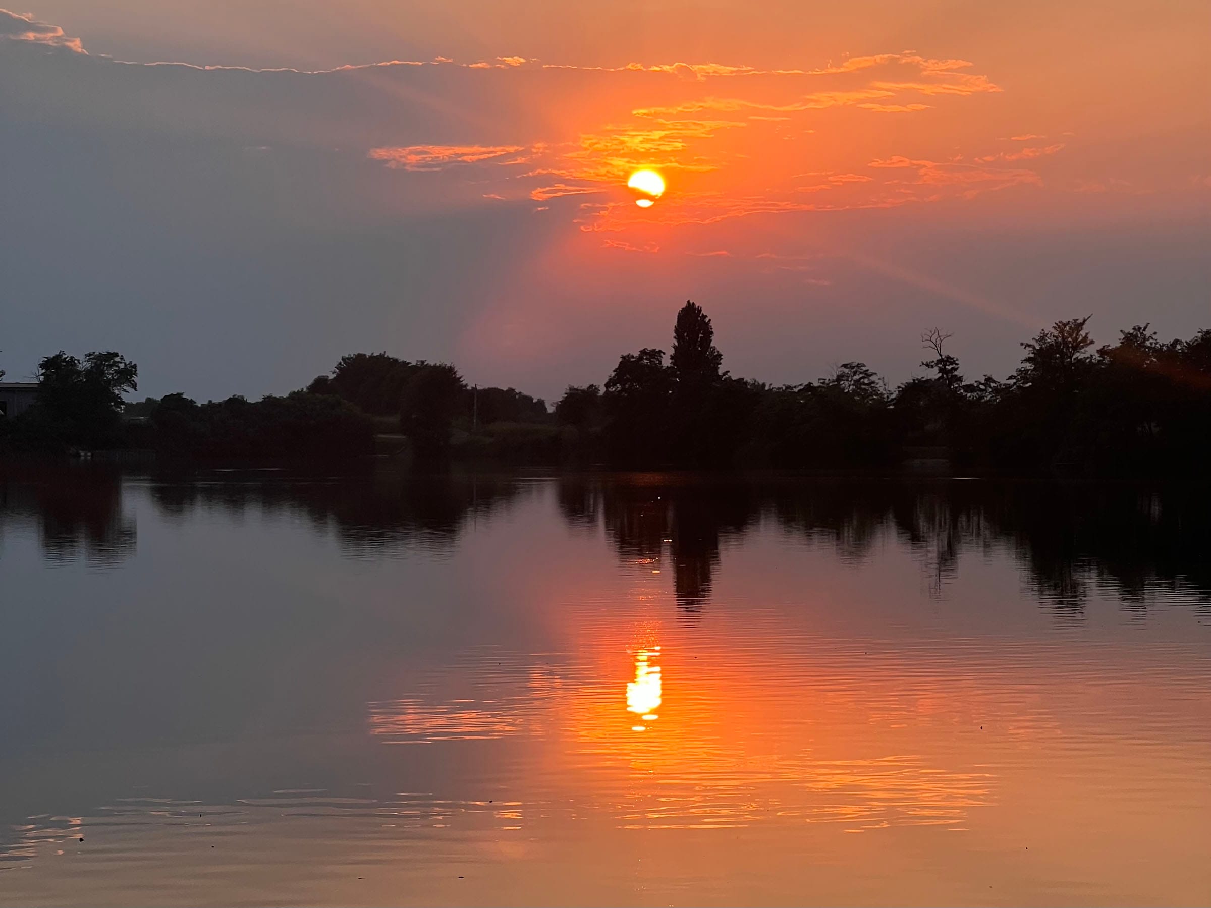 Sunset reflecting on a calm lake.