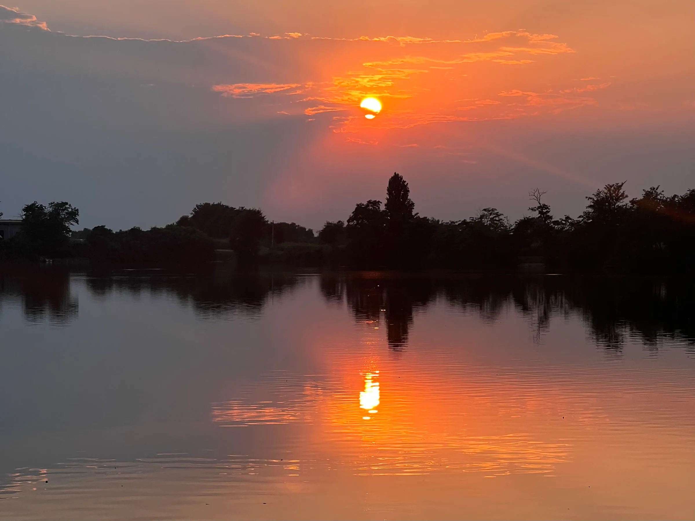 Sunset reflecting on a calm lake.